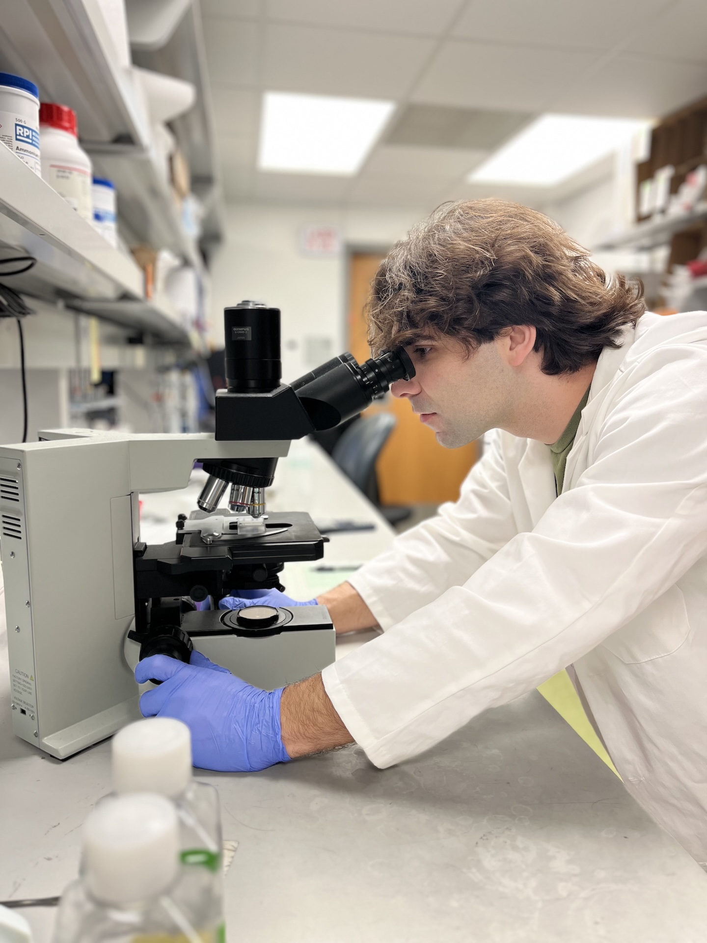 Connor looking through a microscope