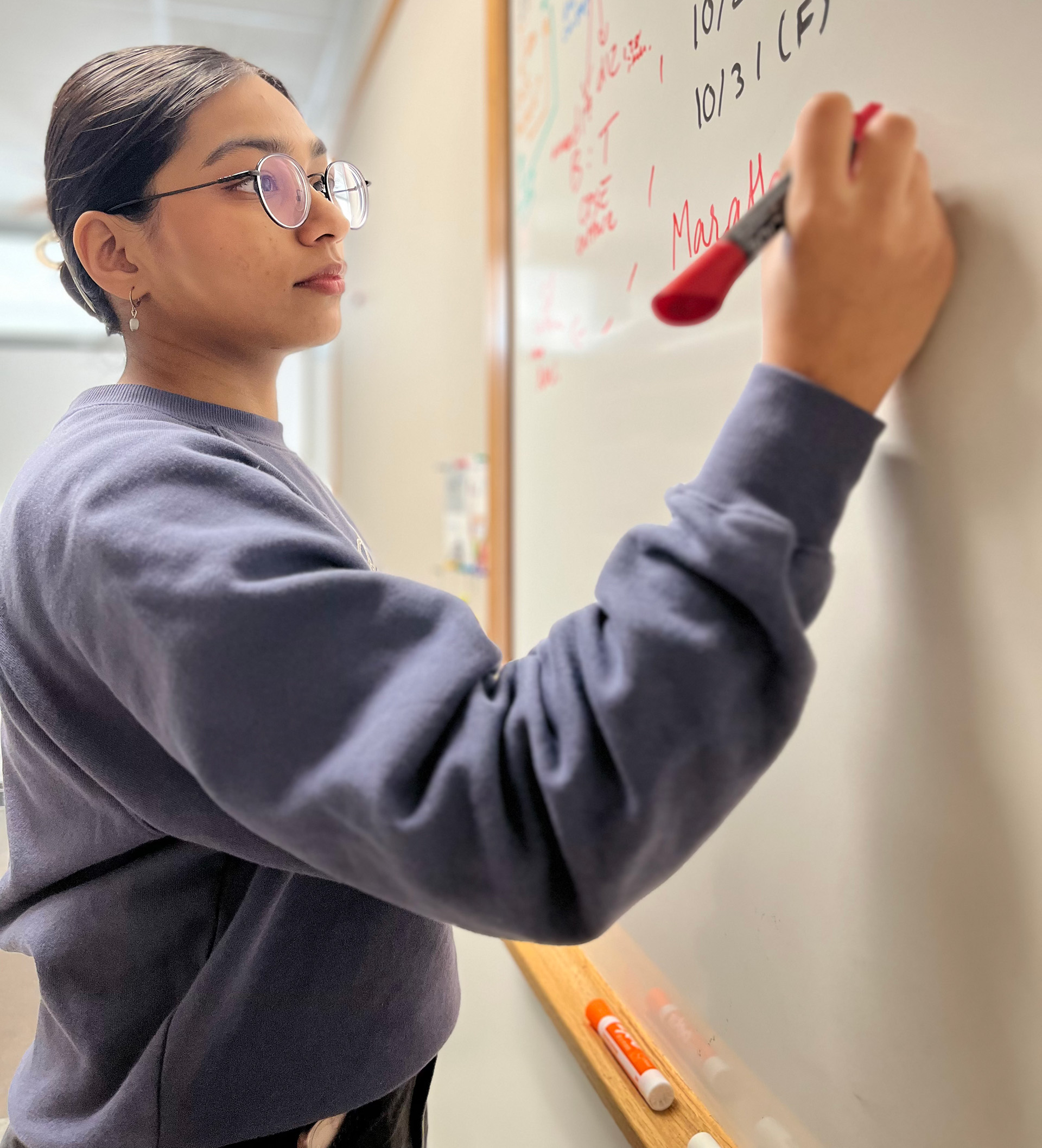 Nimra writing on a whiteboard