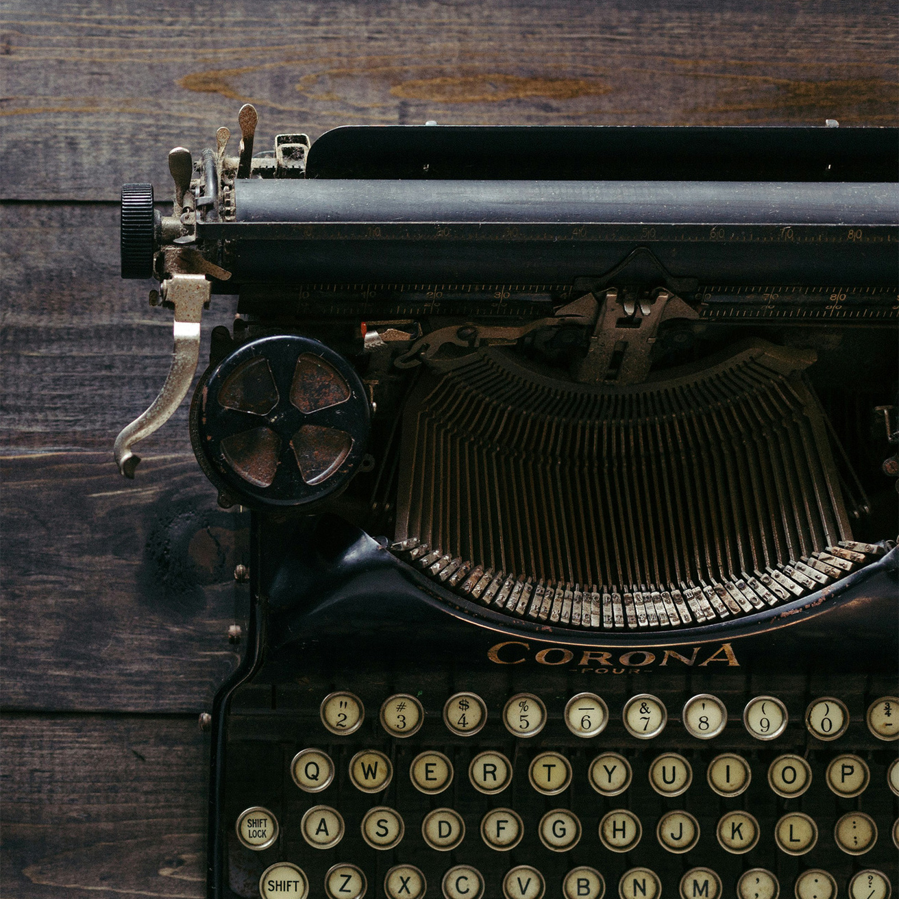 A typewriter sitting on a wooden table