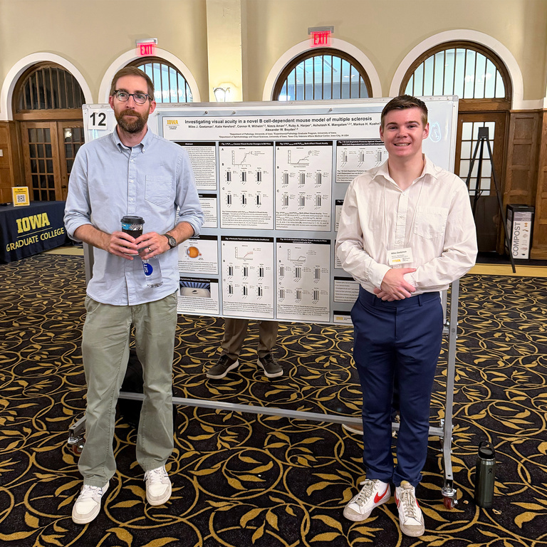 Alex and Miles standing in front of a research poster